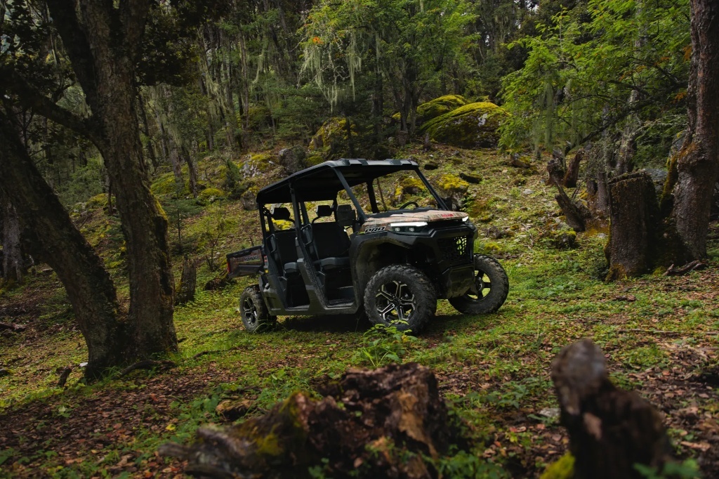 Camouflage UTV navigatingthrough the forest for huntingand cargo transport.jpg