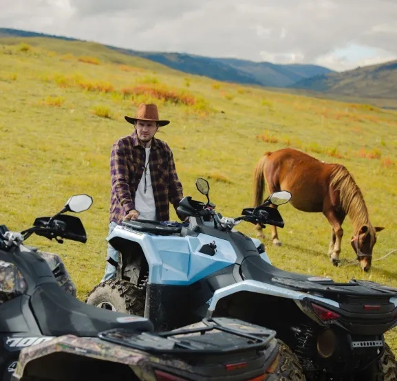 SWM ATV on a ranch with a horse.jpg